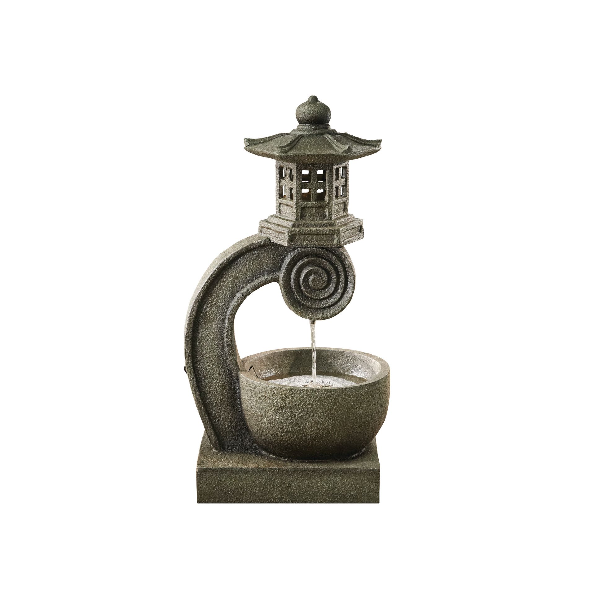Zen garden water fountain with pagoda and stone bowl, water flowing.