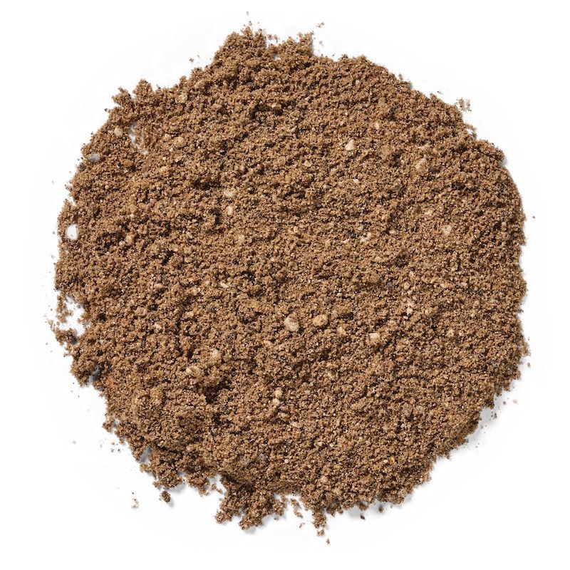 Pile of brown, granular soil on a white background.