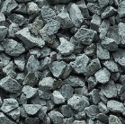 Pile of gray gravel rocks on a white surface.