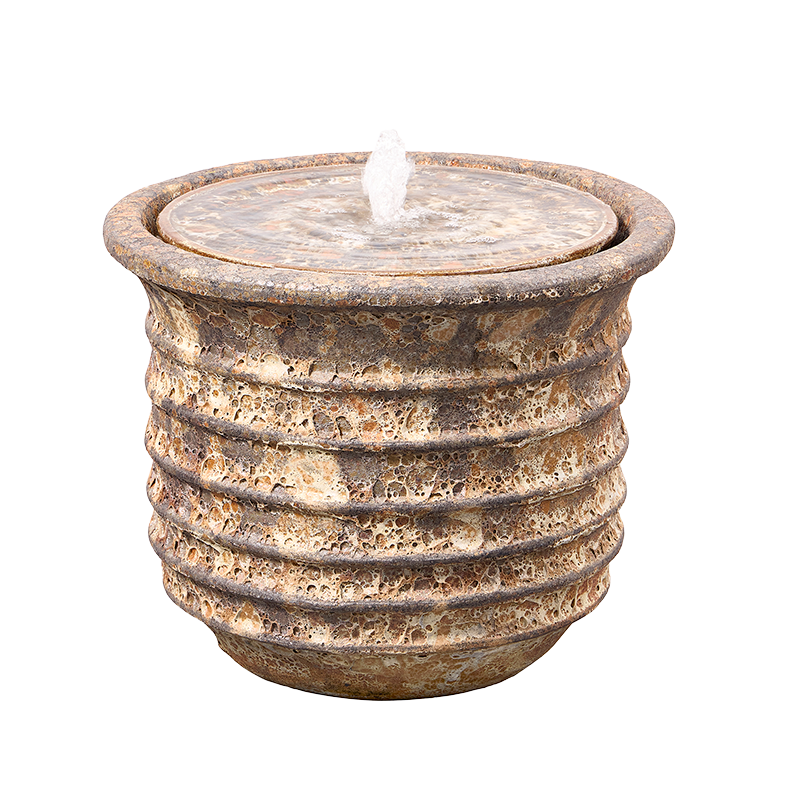 Stone-look, round outdoor fountain with water spouting from the top.