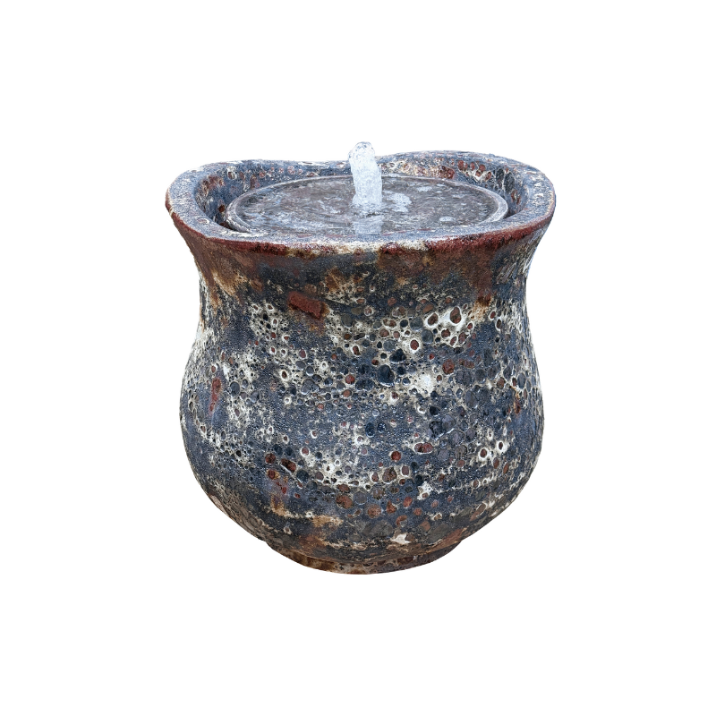 Rustic ceramic candleholder with melted wax and wick.