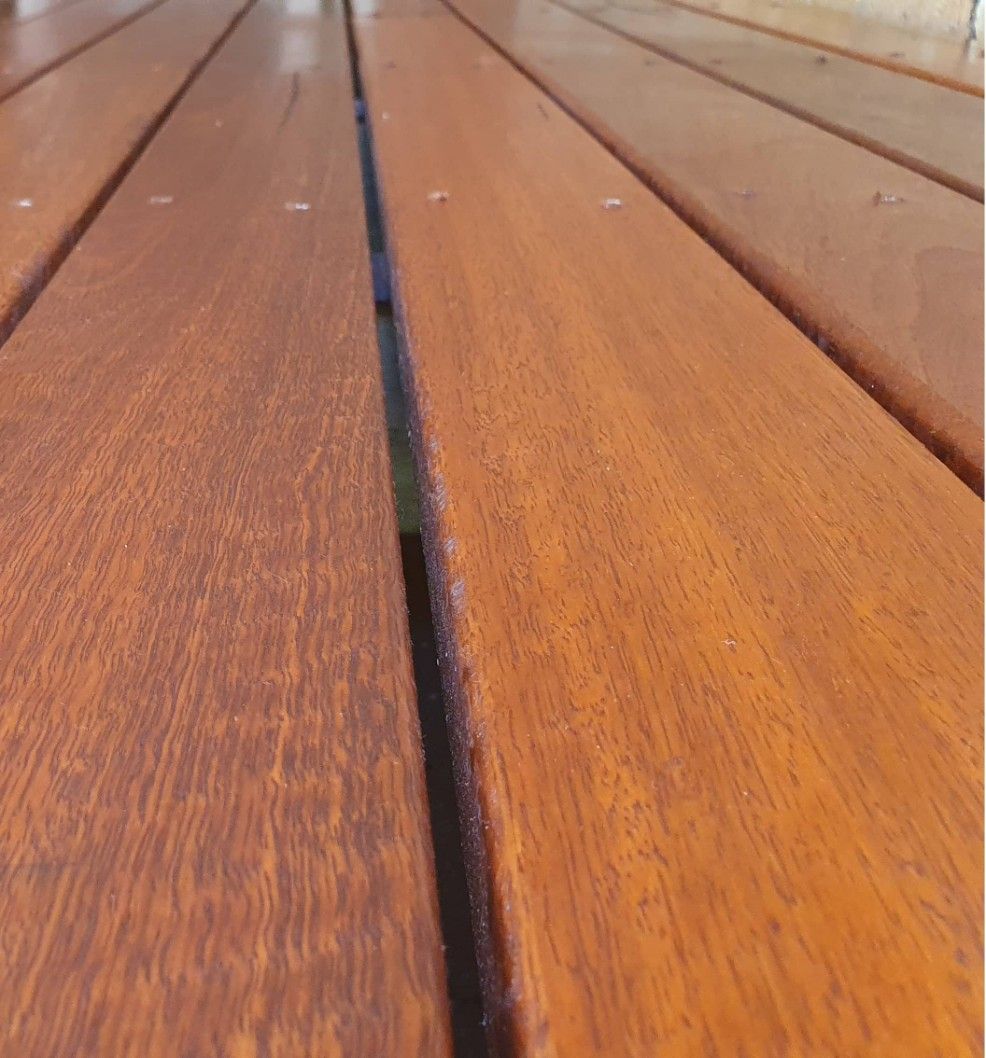 A Close Up Of A Wooden Deck With A Black Line Between The Boards — Johnson's Timber Agencies In Bawley Point, NSW