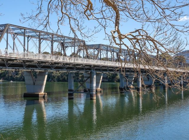 A Bridge Over A Body Of Water With Trees In The Background — Johnson's Timber Agencies In Nowra, NSW
