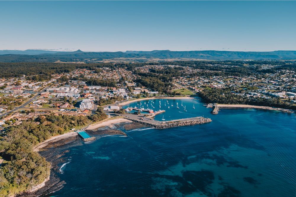 An Aerial View Of A Harbor With A City In The Background — Johnson's Timber Agencies In Ulladulla, NSW