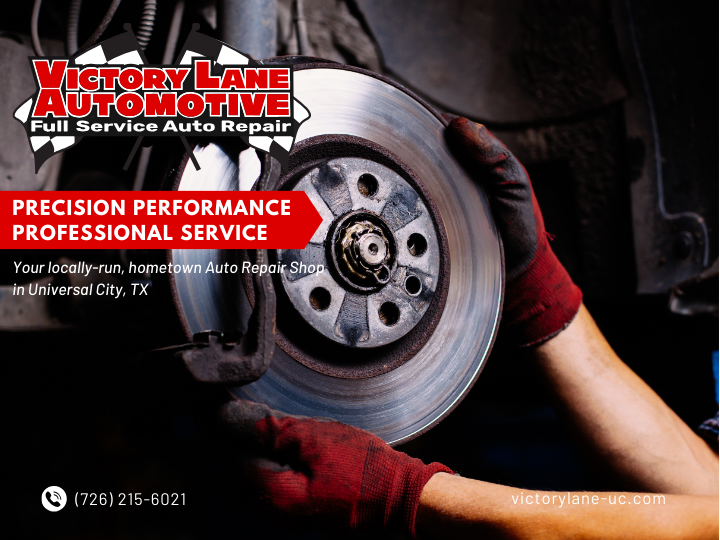 Mechanic holding a brake rotor, with Victory Lane Automotive logo, advertisement for auto repair in Universal City, TX. | Victory Lane Automotive