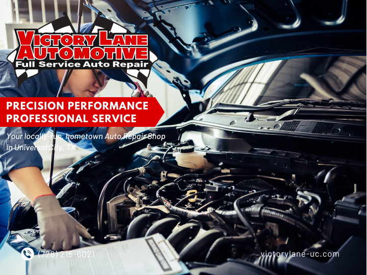 Mechanic working on a car engine at Victory Lane Automotive shop. Red banner states 