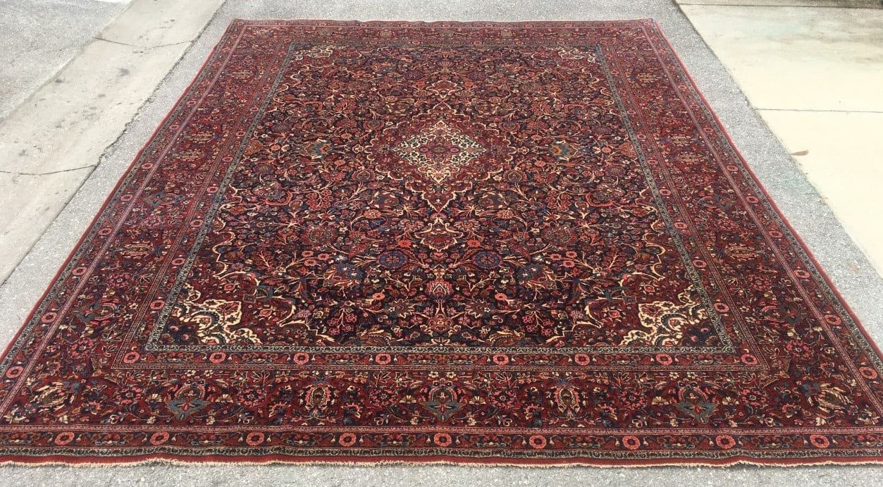 Red and burgundy Persian rug with floral motifs.