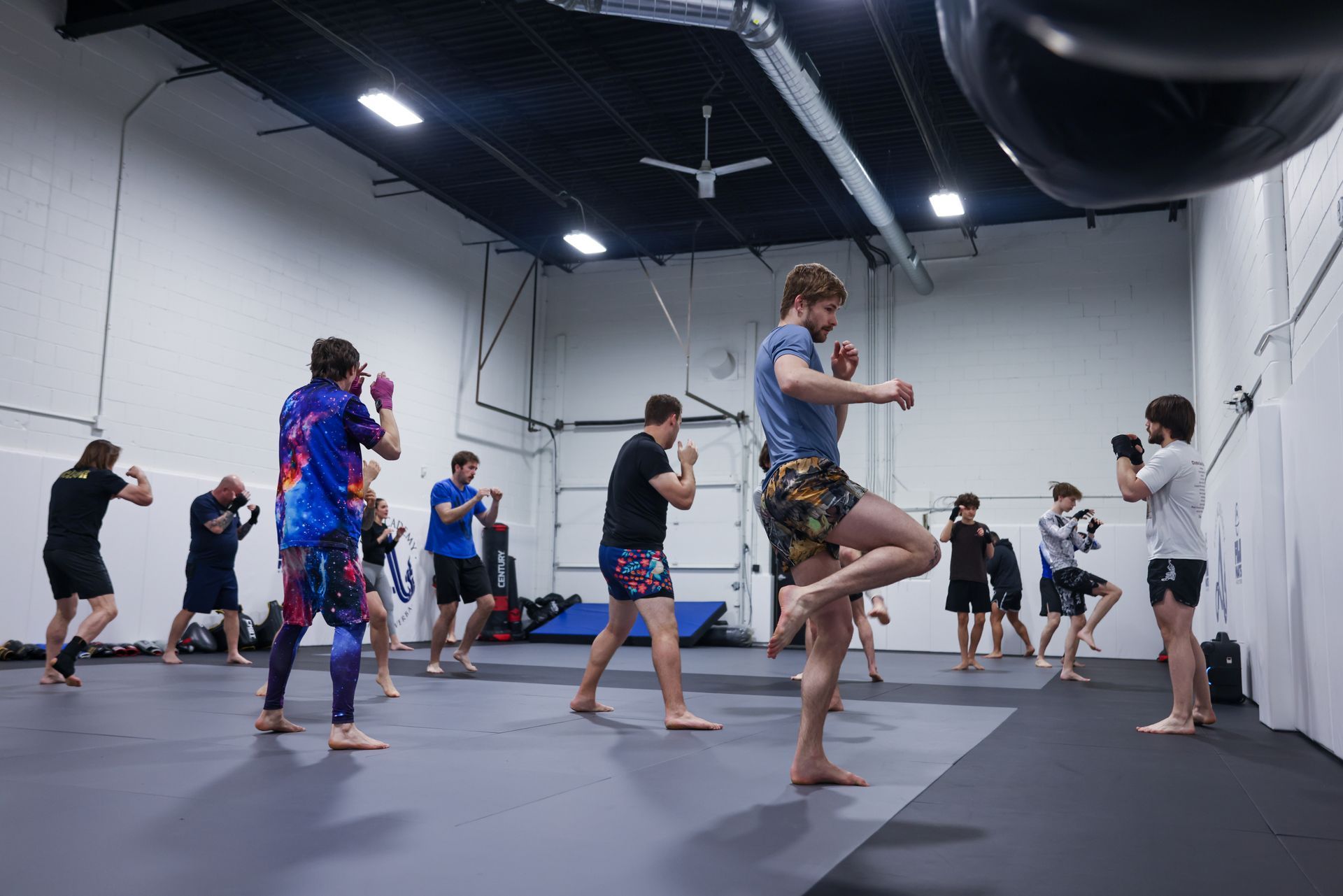 Adults drilling Brazilian Jiu-Jitsu techniques at The Academy Eden Prairie in Minneapolis, MN.