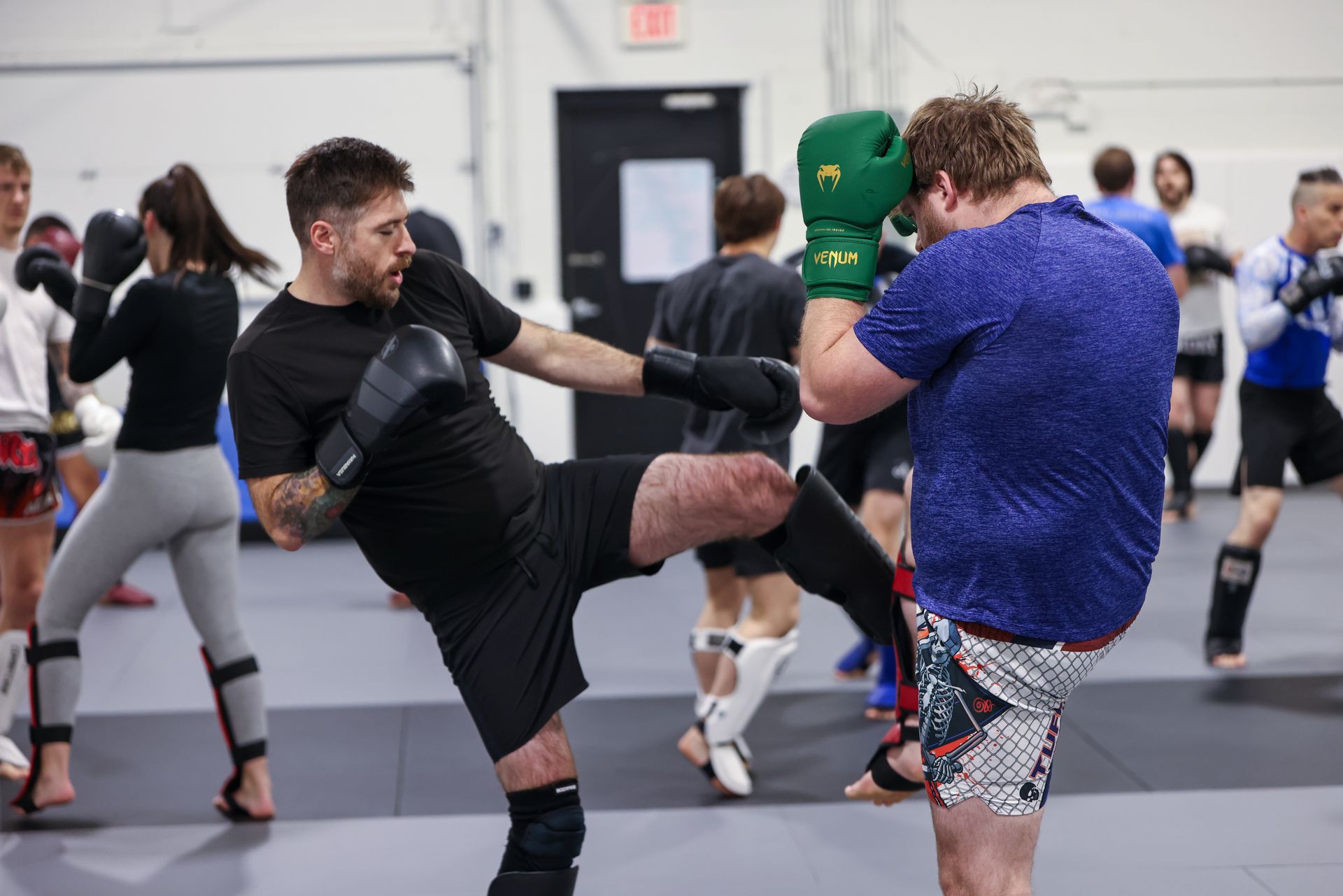 Adult Brazilian Jiu-Jitsu partners drilling technique at The Academy Eden Prairie in Minneapolis, MN