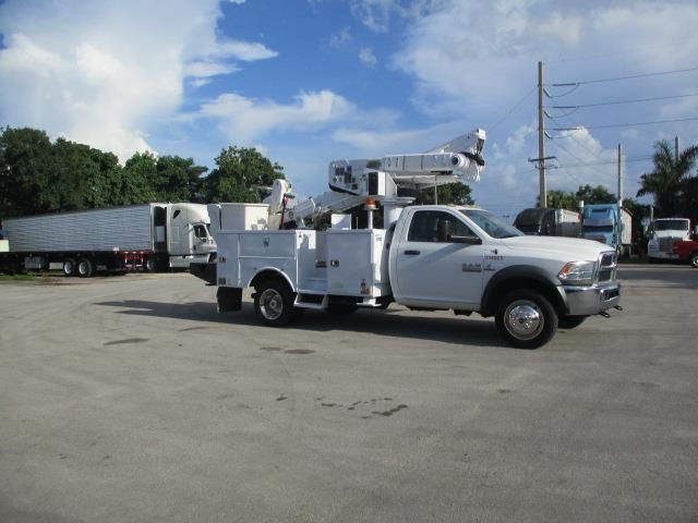 A white utility truck is parked in a parking lot