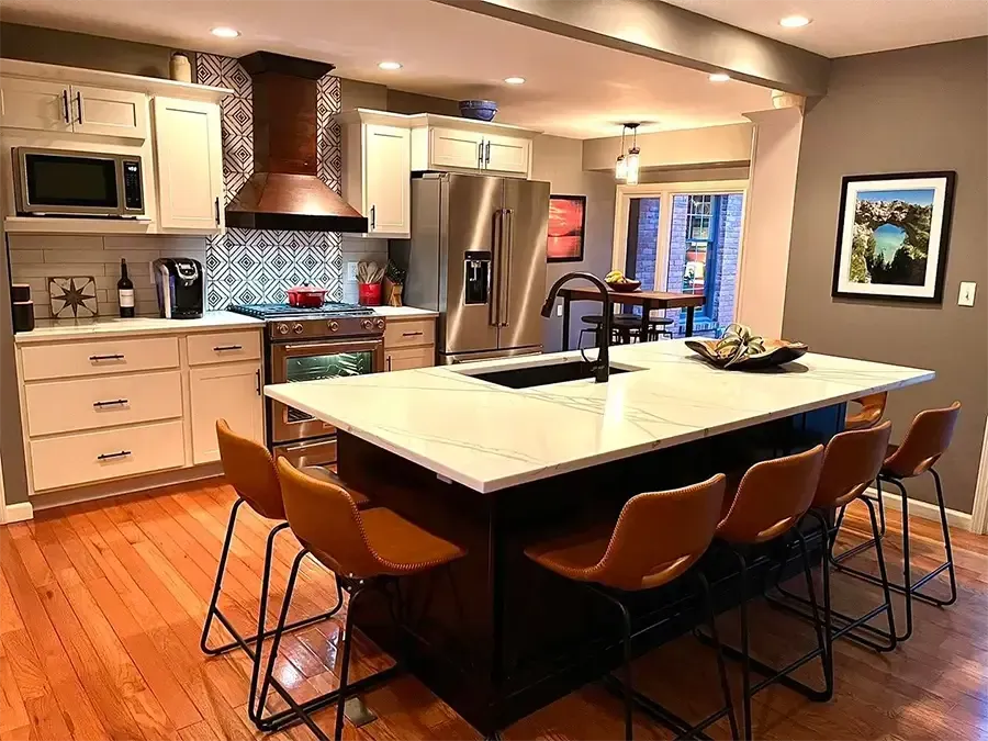 Modern kitchen with a large island, stainless steel appliances, and warm wood cabinetry