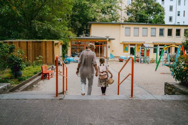 A woman and a child are walking down stairs in a park.