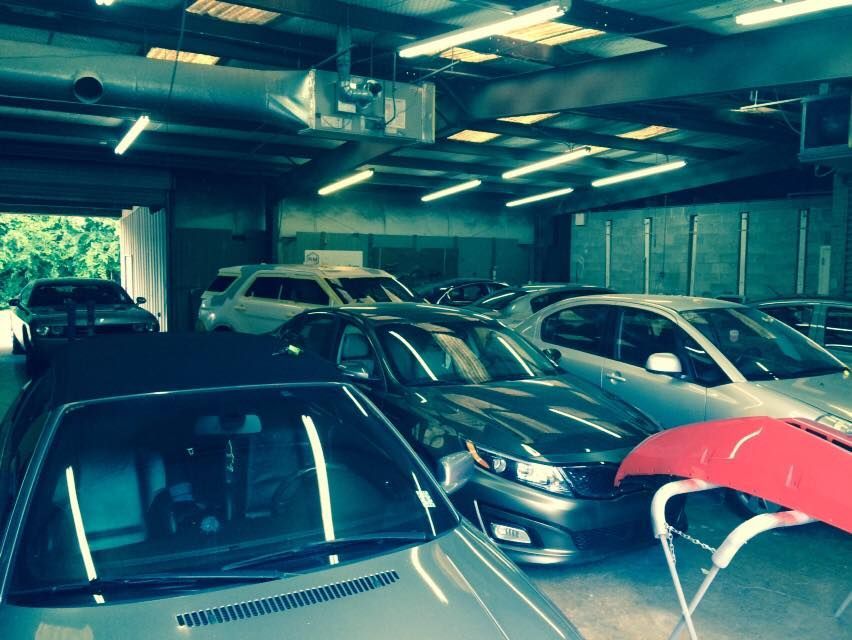 A lot of cars are parked in a garage.