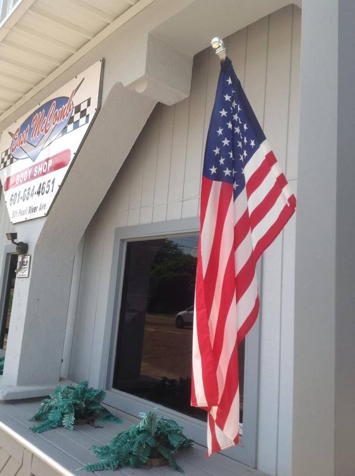 An american flag is hanging outside of a building