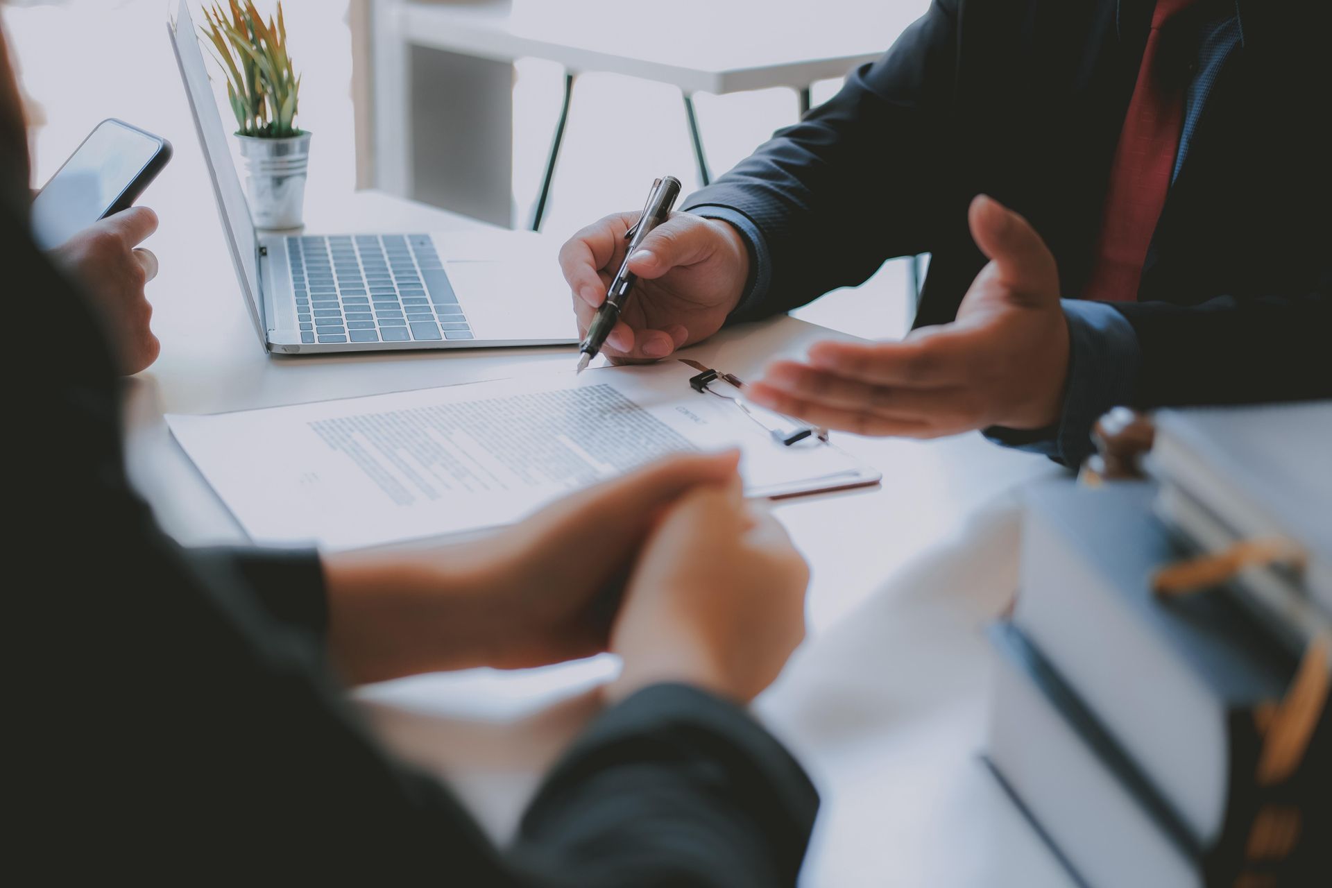 Person signing a document, being assisted by another. 
