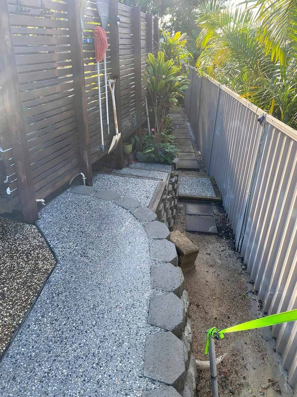 A Path Leading to A Fence with Gravel and Rocks — Shaka Concreting In South Golden Beach, NSW