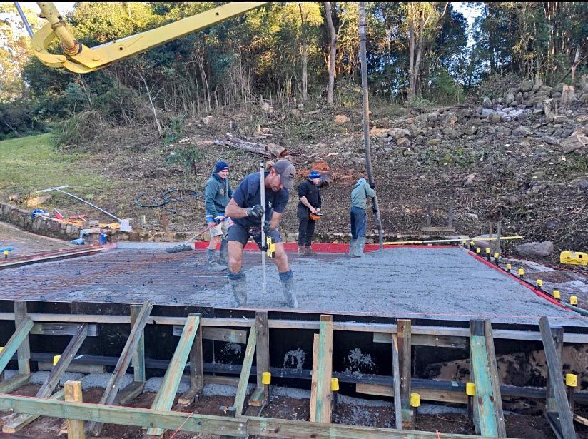 A Group of Construction Workers Are Working on A Concrete Floor — Shaka Concreting In Byron Bay, NSW