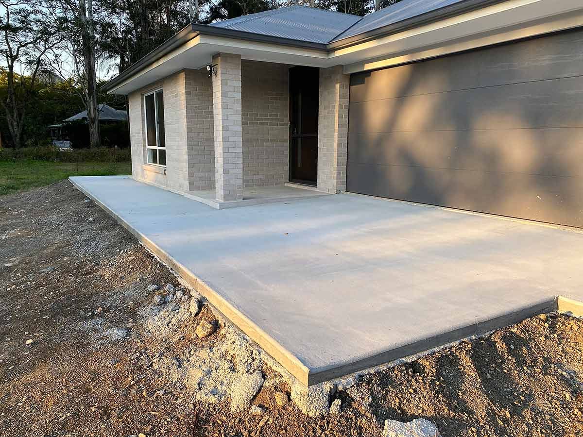 A Concrete Driveway Is Being Built in Front of A House — Shaka Concreting In South Golden Beach, NSW