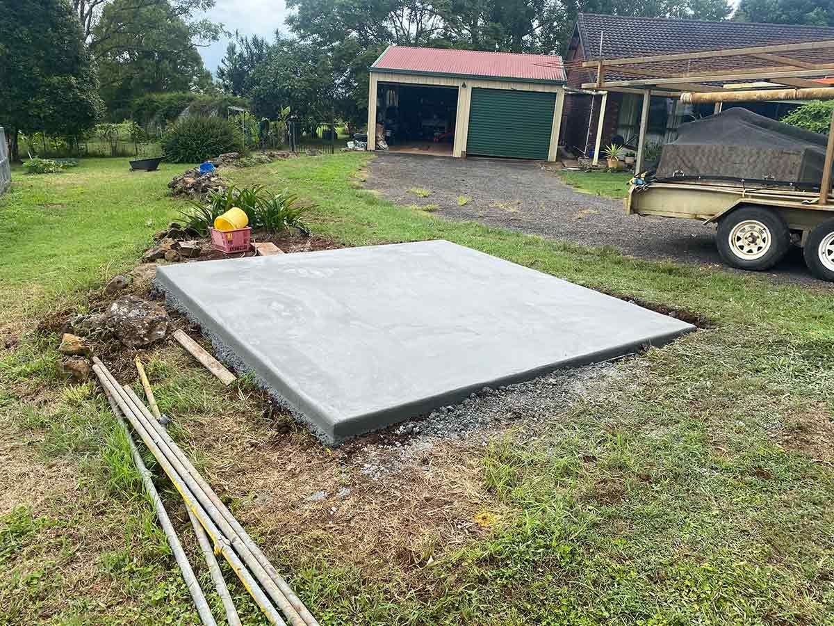 A Concrete Slab Is Being Built in A Yard Next to A Trailer — Shaka Concreting In South Golden Beach, NSW
