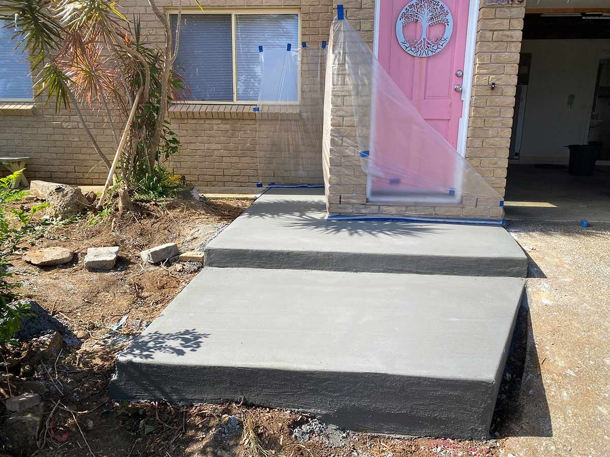 A Concrete Walkway Is Being Built in Front of A House with A Pink Door — Shaka Concreting In South Golden Beach, NSW