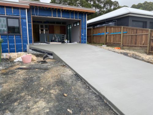 A Concrete Driveway Is Being Built in Front of A House — Shaka Concreting In Mullumbimby, NSW