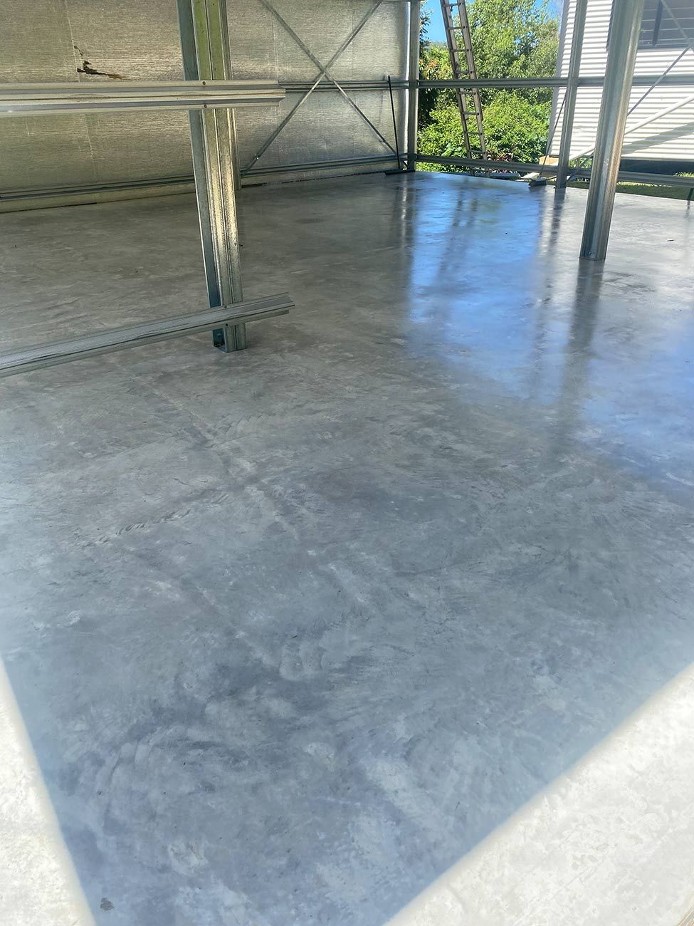 A Concrete Floor with A Metal Structure in The Background — Shaka Concreting In South Golden Beach, NSW