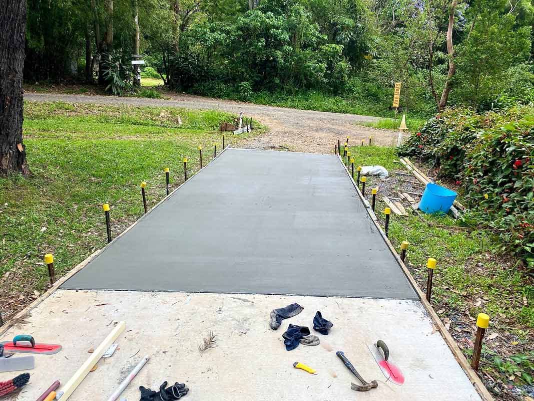 A Concrete Driveway Is Being Built with Tools on The Ground — Shaka Concreting In Tweed Heads, NSW