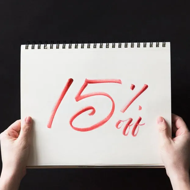 M and M offers 15% discounts to qualifying members 15% discount written on piece of paper