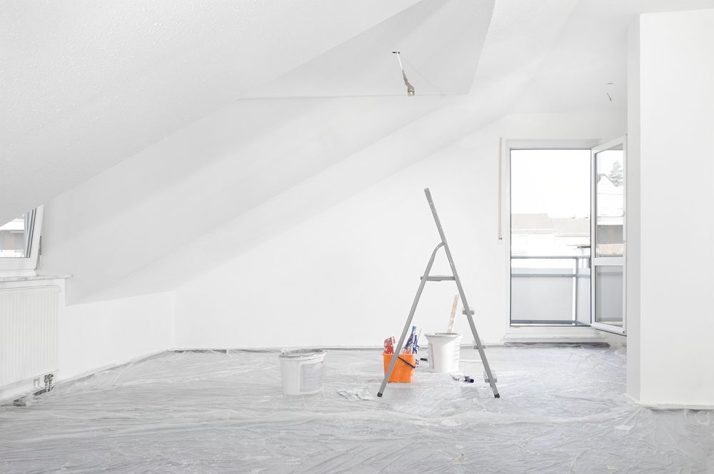 Room Being Painted with White Walls, a Ladder, and Paint Supplies — SS Building Services in Townsville, QLD