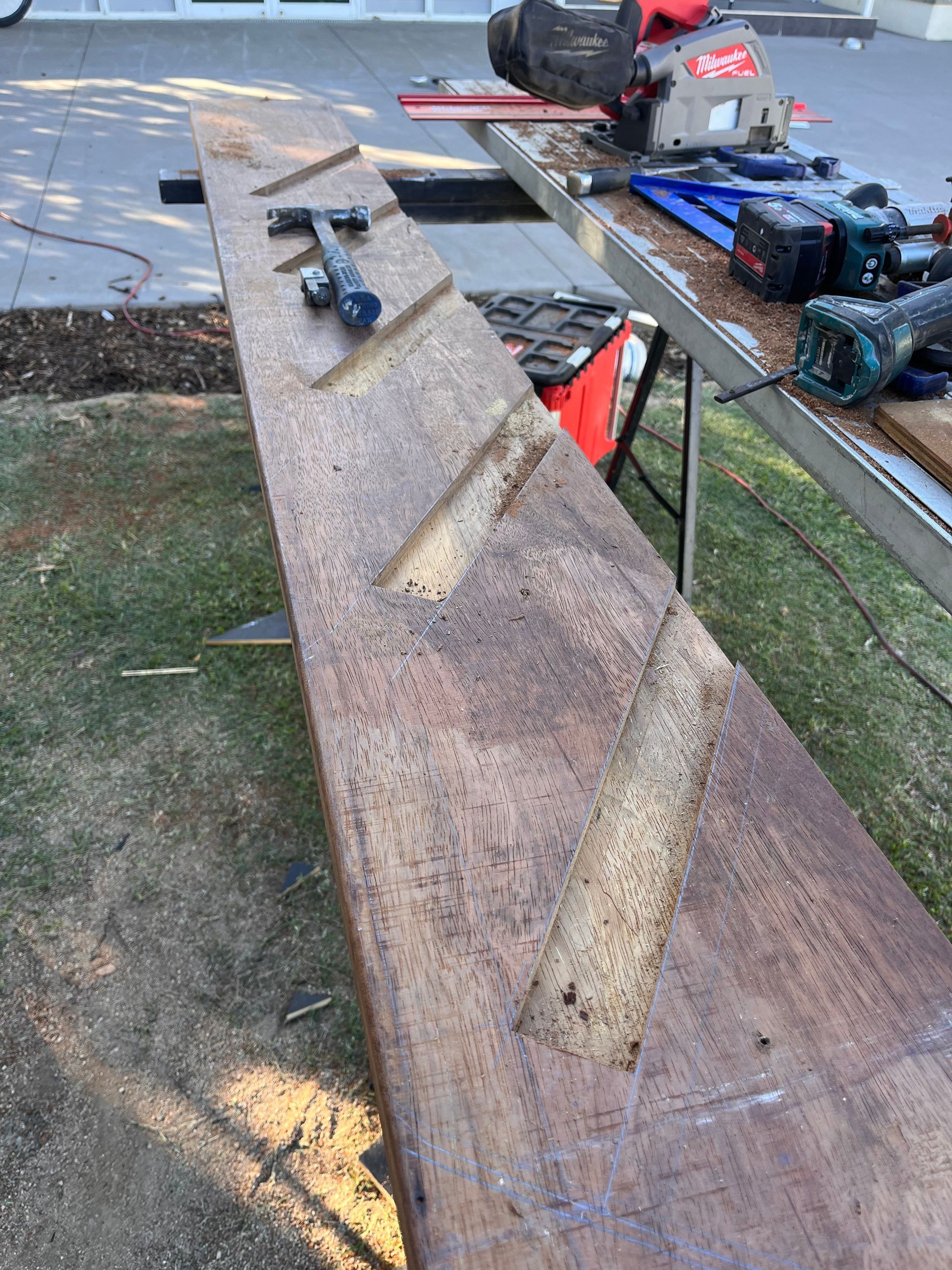 Long Wooden Plank with Adhesive Patches and Power Tools on A Workbench Outdoors — SS Building Services in Townsville, QLD