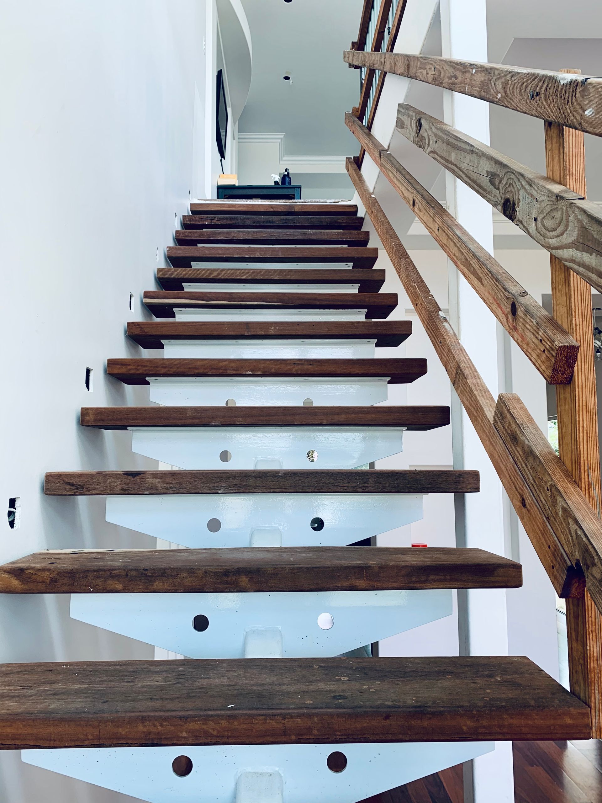 Narrow Indoor Staircase with Wooden Steps, White Walls, and A Rustic Wooden Railing — SS Building Services in Townsville, QLD