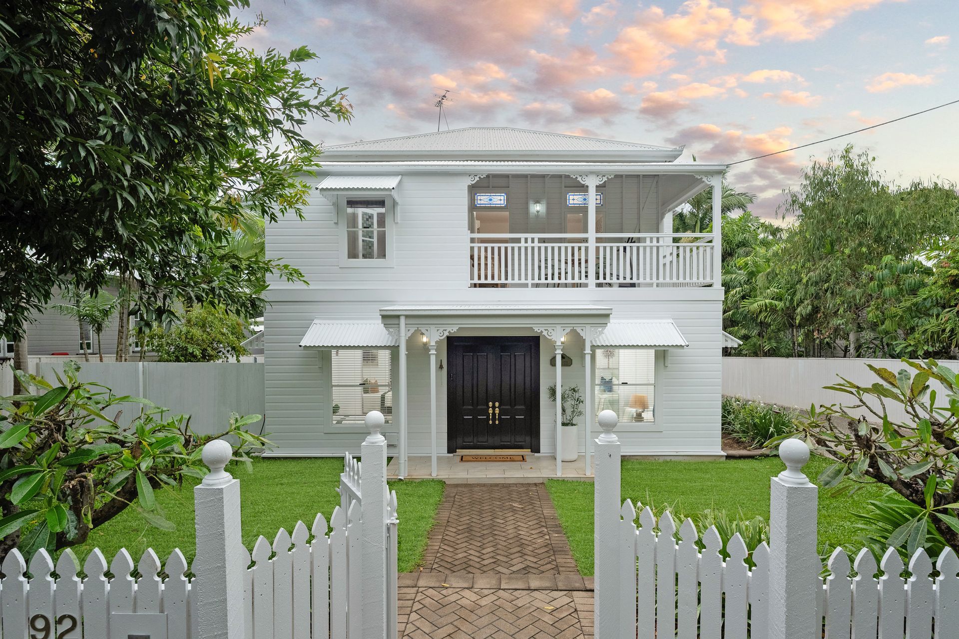 White Two Story House with A Front Gate — SS Building Services in Townsville, QLD