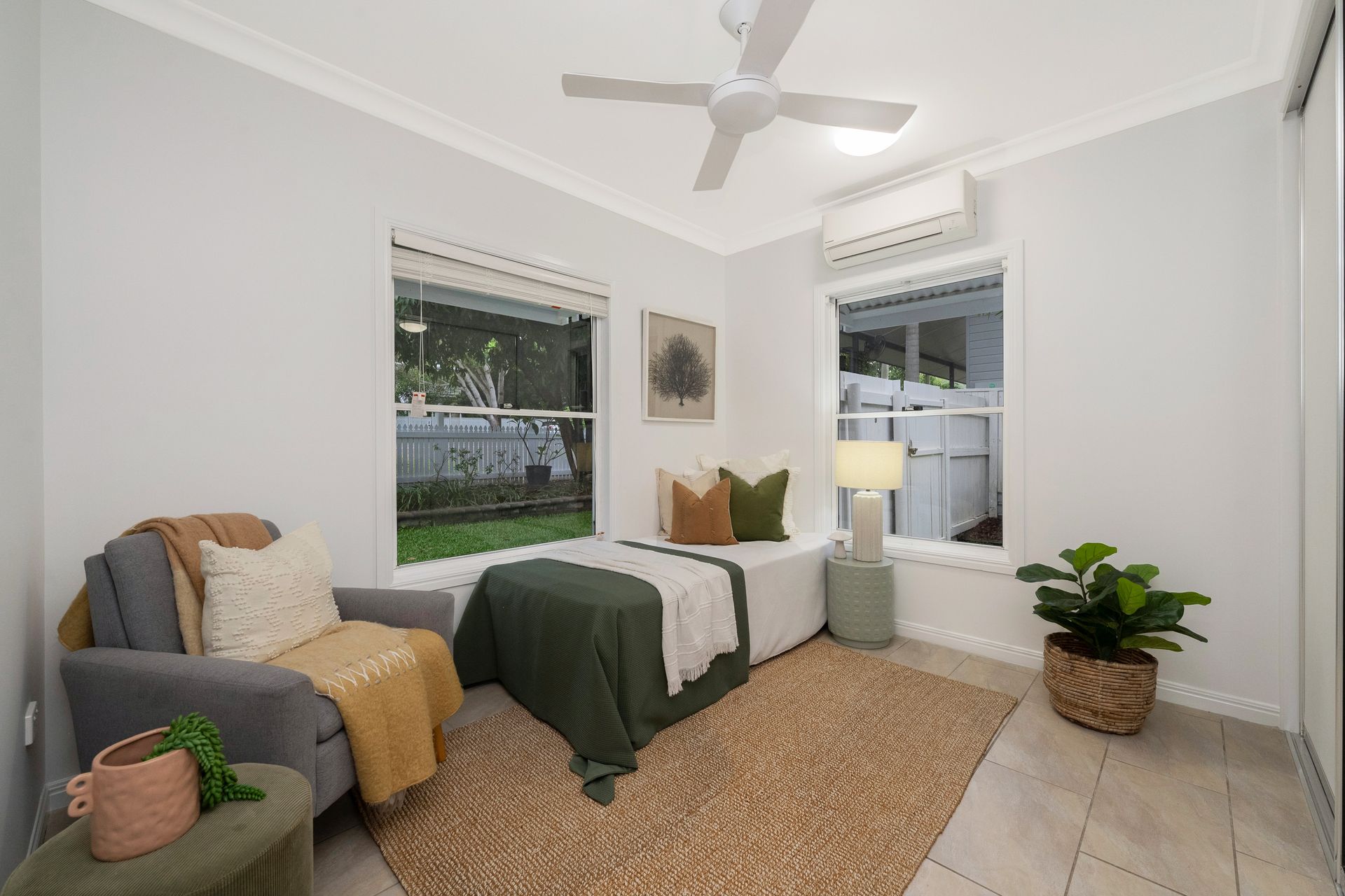 Bedroom with Twin Beds, White Walls, Two Windows and A Potted Plant on The Floor — SS Building Services in Townsville, QLD