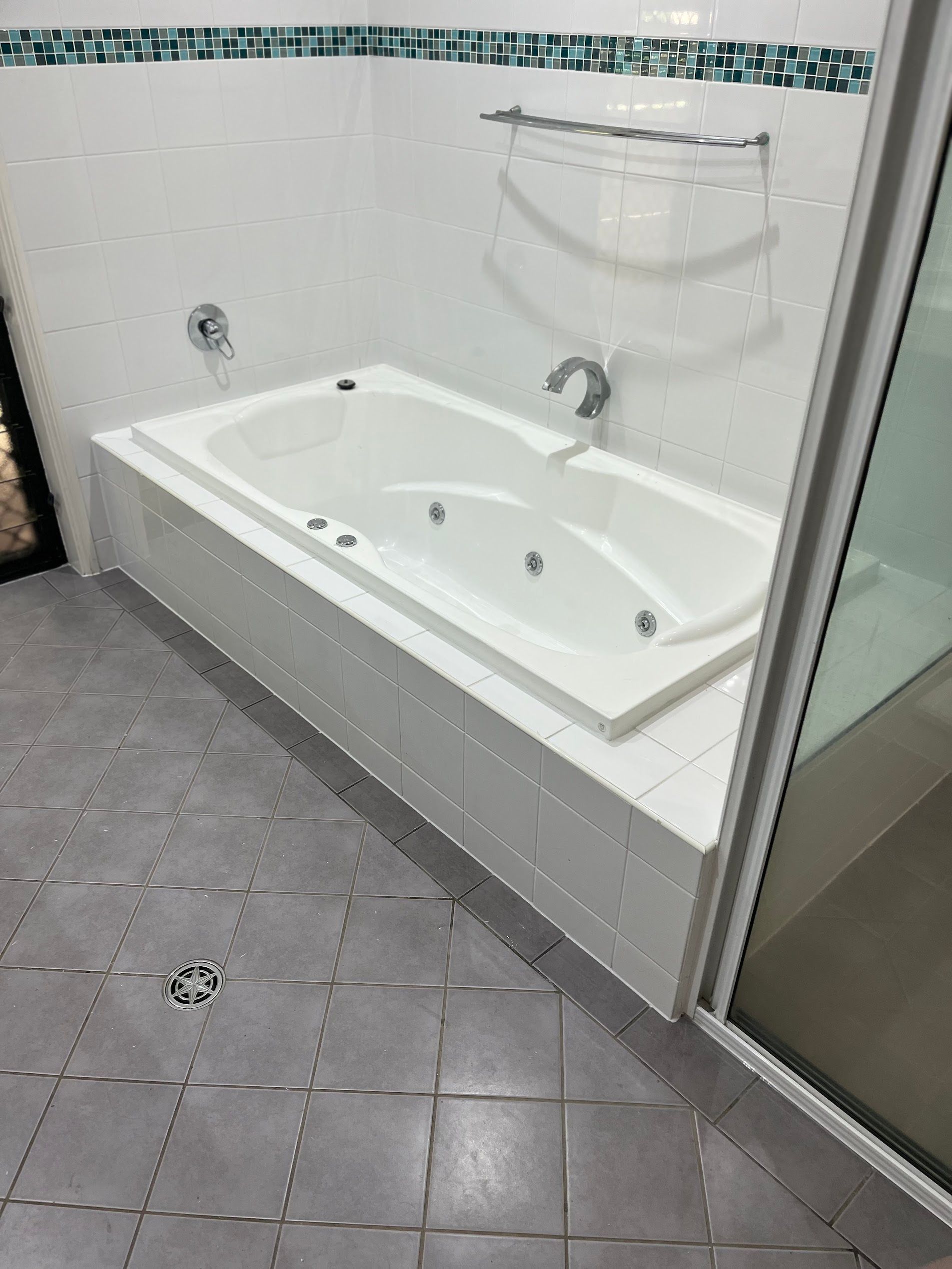 White Bathroom with A Built In Corner Jetted Tub — SS Building Services in Townsville, QLD