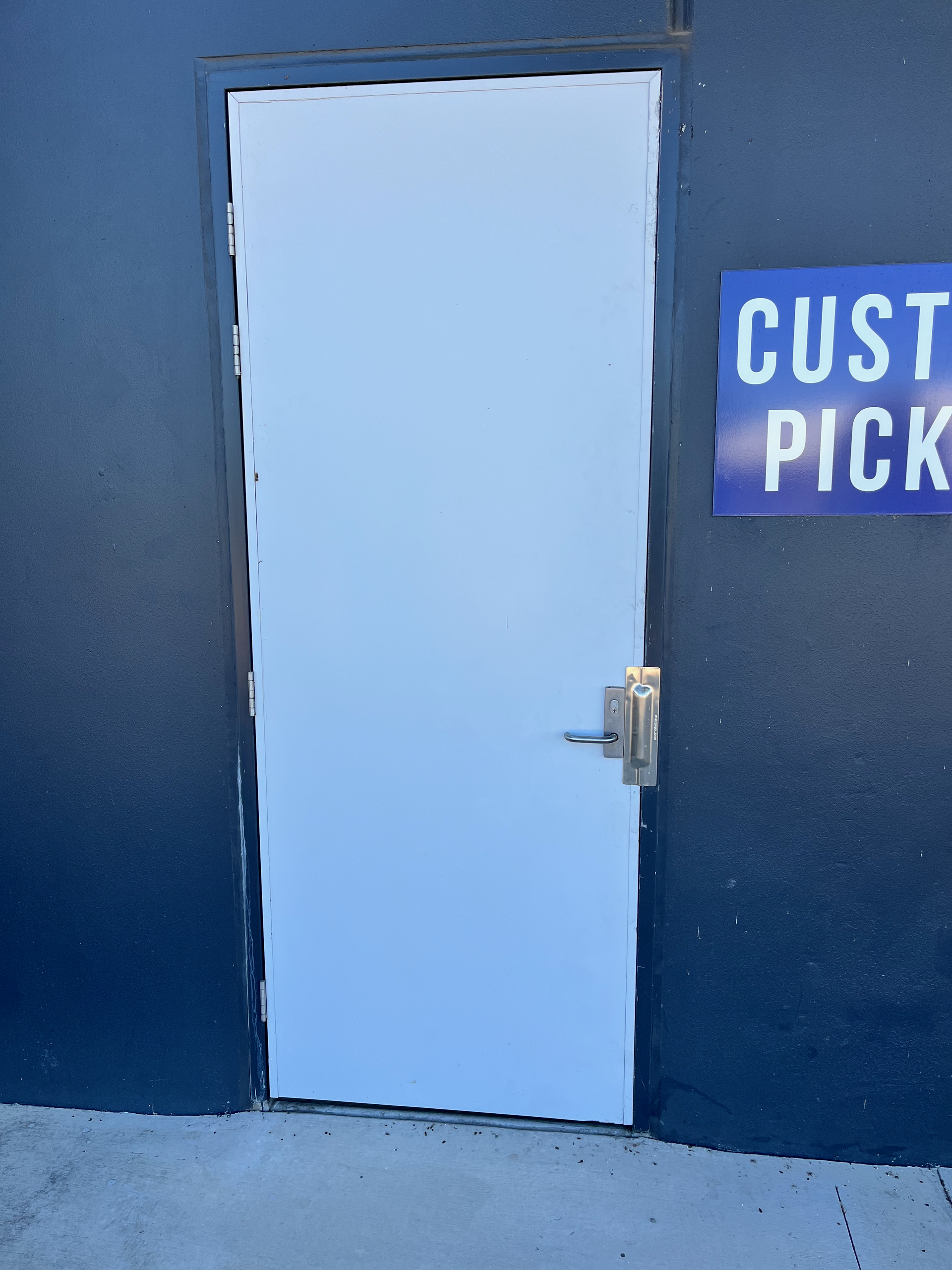 A White Door With a Small Window on the Side of It — SS Building Services in Townsville, QLD
