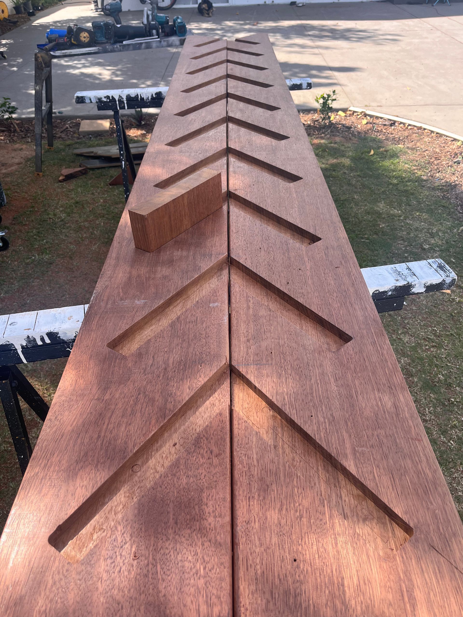 Shingled Roof Ridge with Repeating Triangular Vents Outdoors in Sunlight — SS Building Services in Townsville, QLD