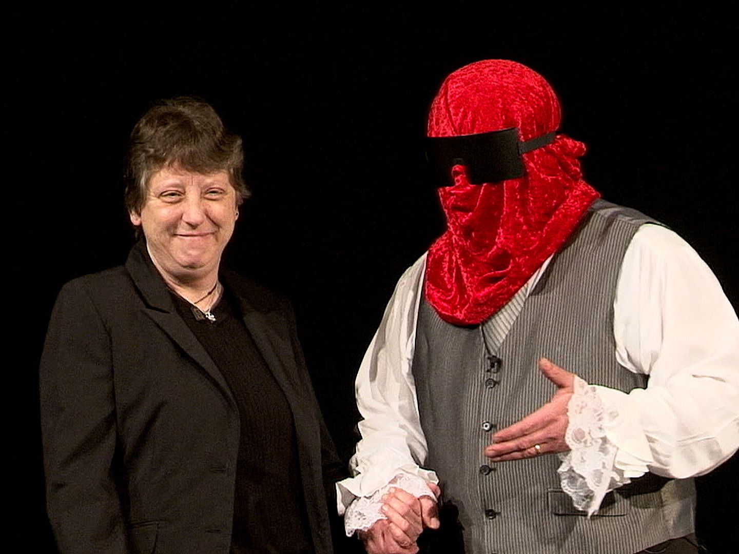 A man wearing a red mask is shaking hands with a woman in Boston