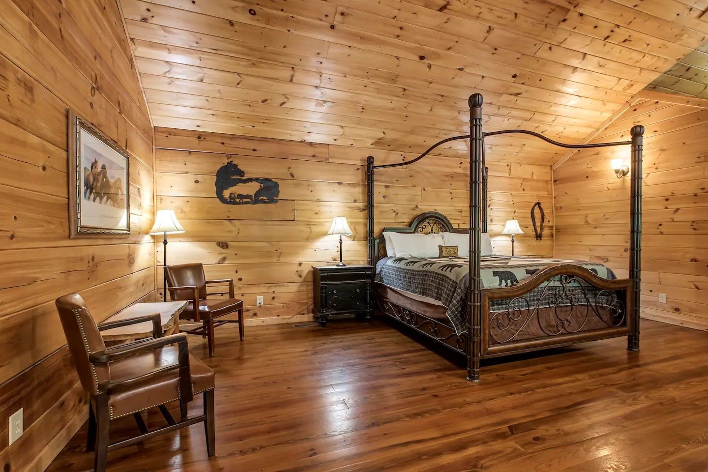 Rustic wooden bedroom with log walls, four-poster bed, chair, dresser, and warm lighting