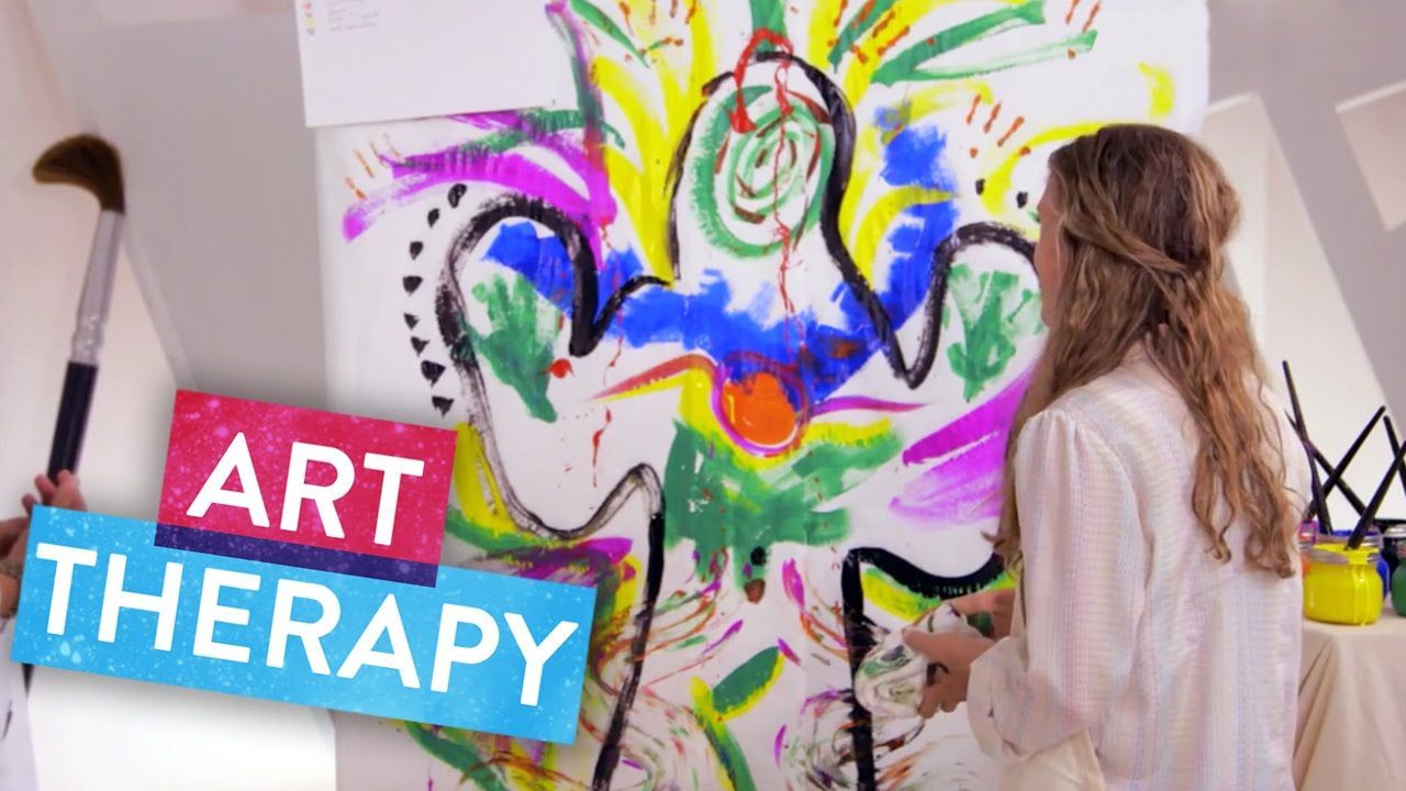 Young  teen girl standing in front of art work recently painted on the wall