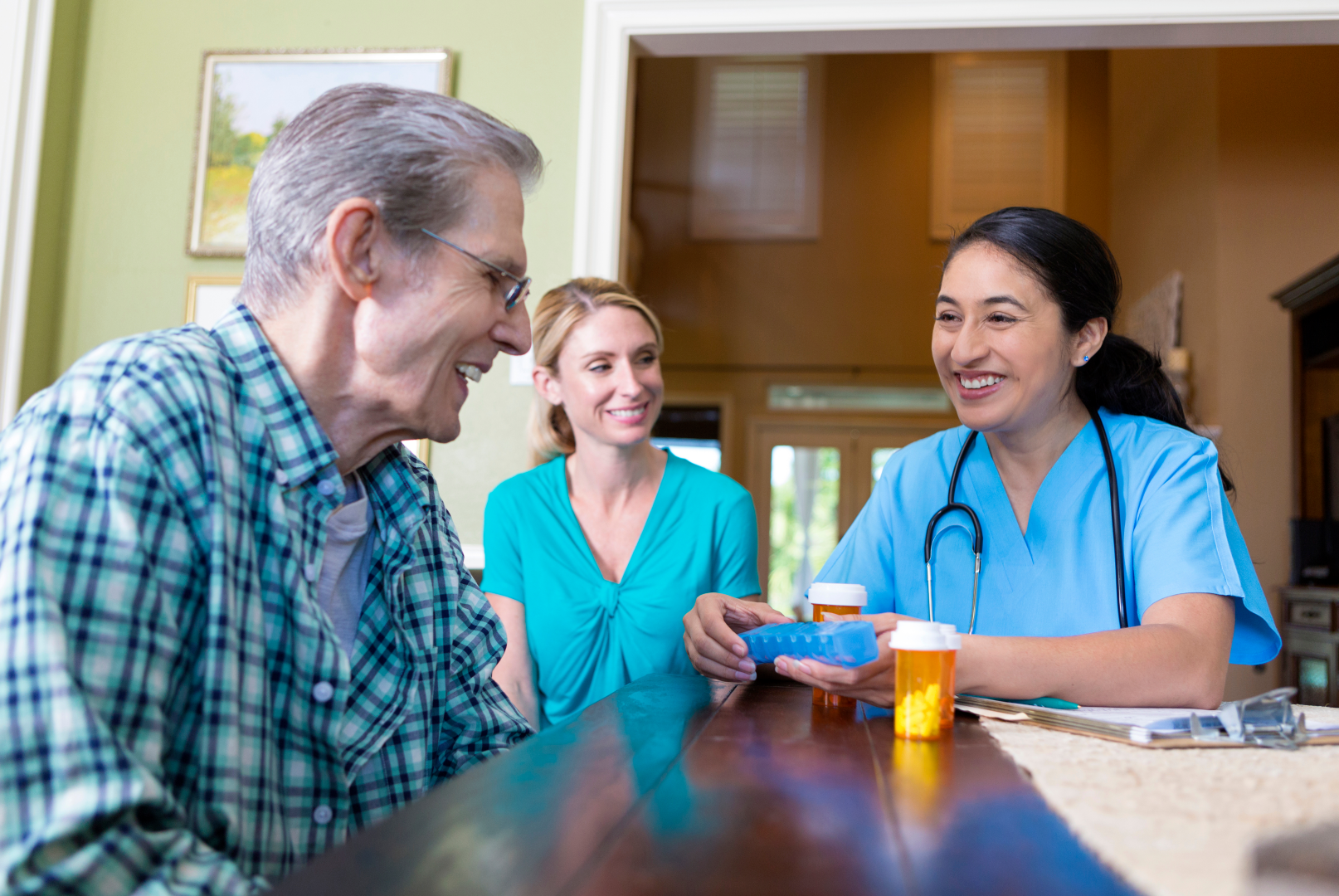 a nurse is giving an elderly man a pill box, Angel Leaf Home Care Provider