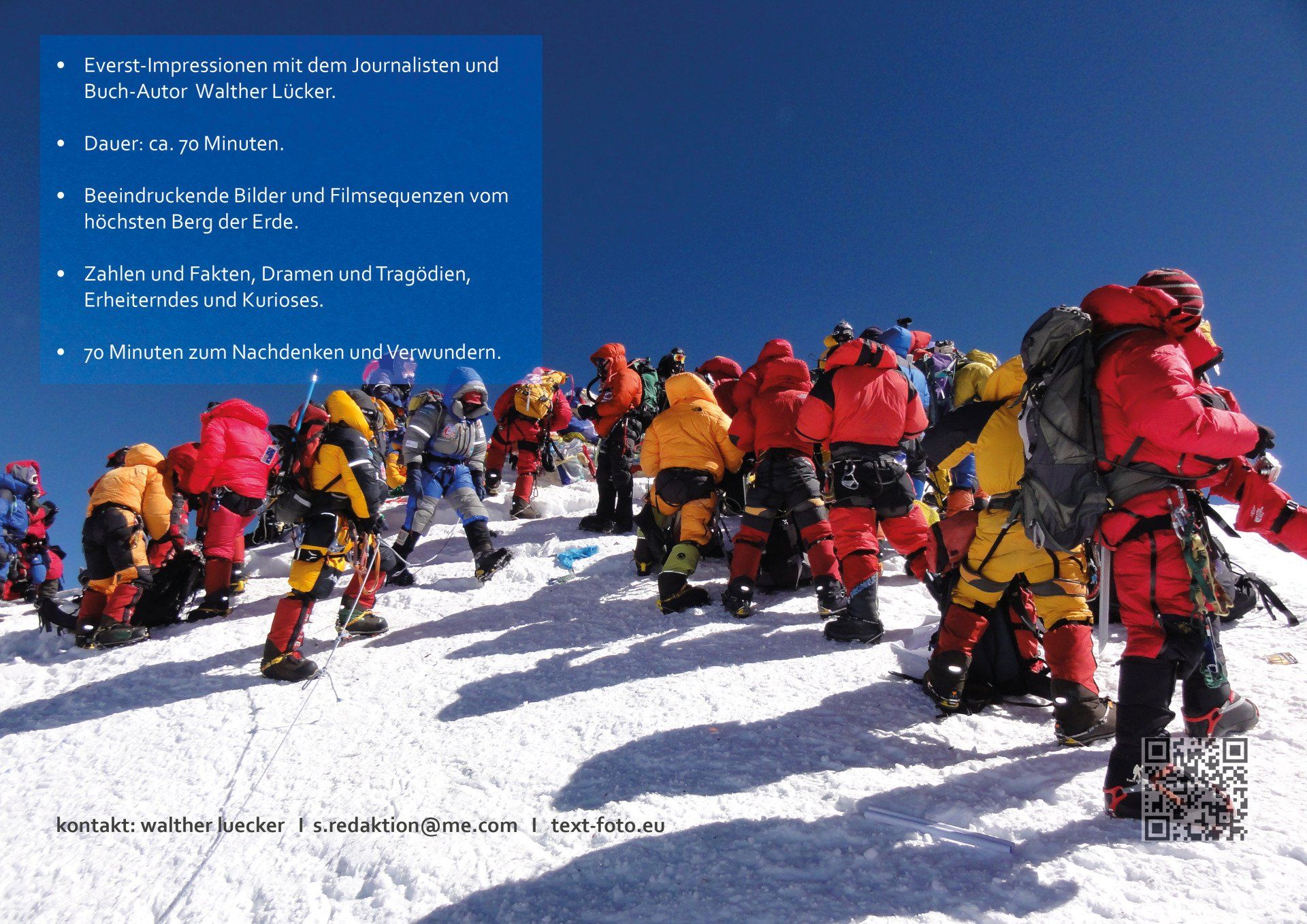 Eine Gruppe von Menschen steht auf einem schneebedeckten Berggipfel