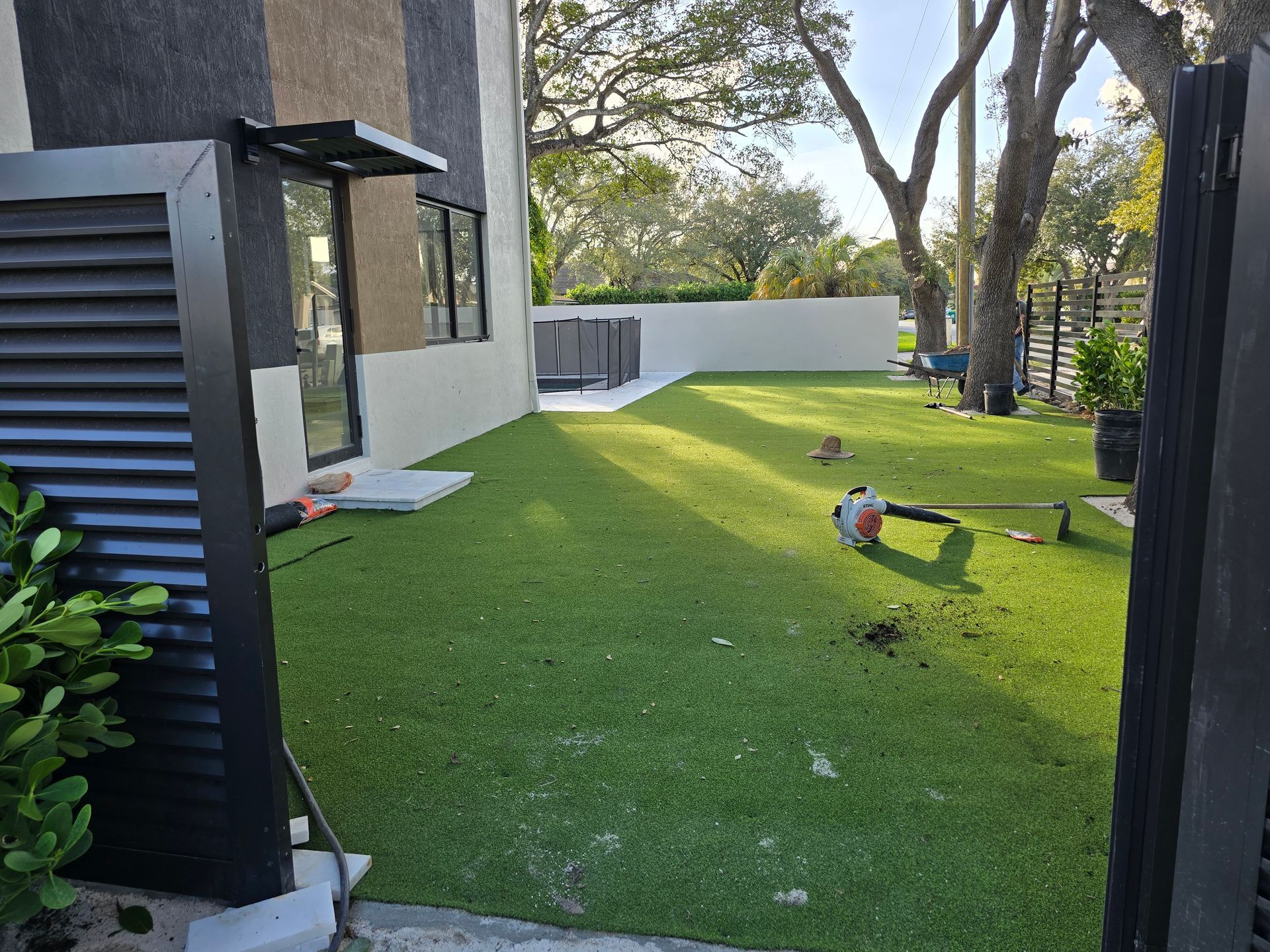 A lawn mower is sitting on top of a lush green lawn.