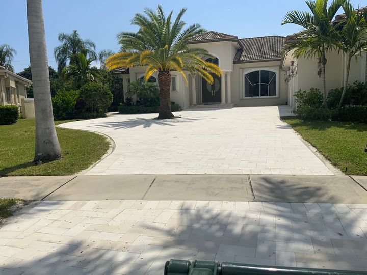 A large swimming pool is in the backyard of a house.