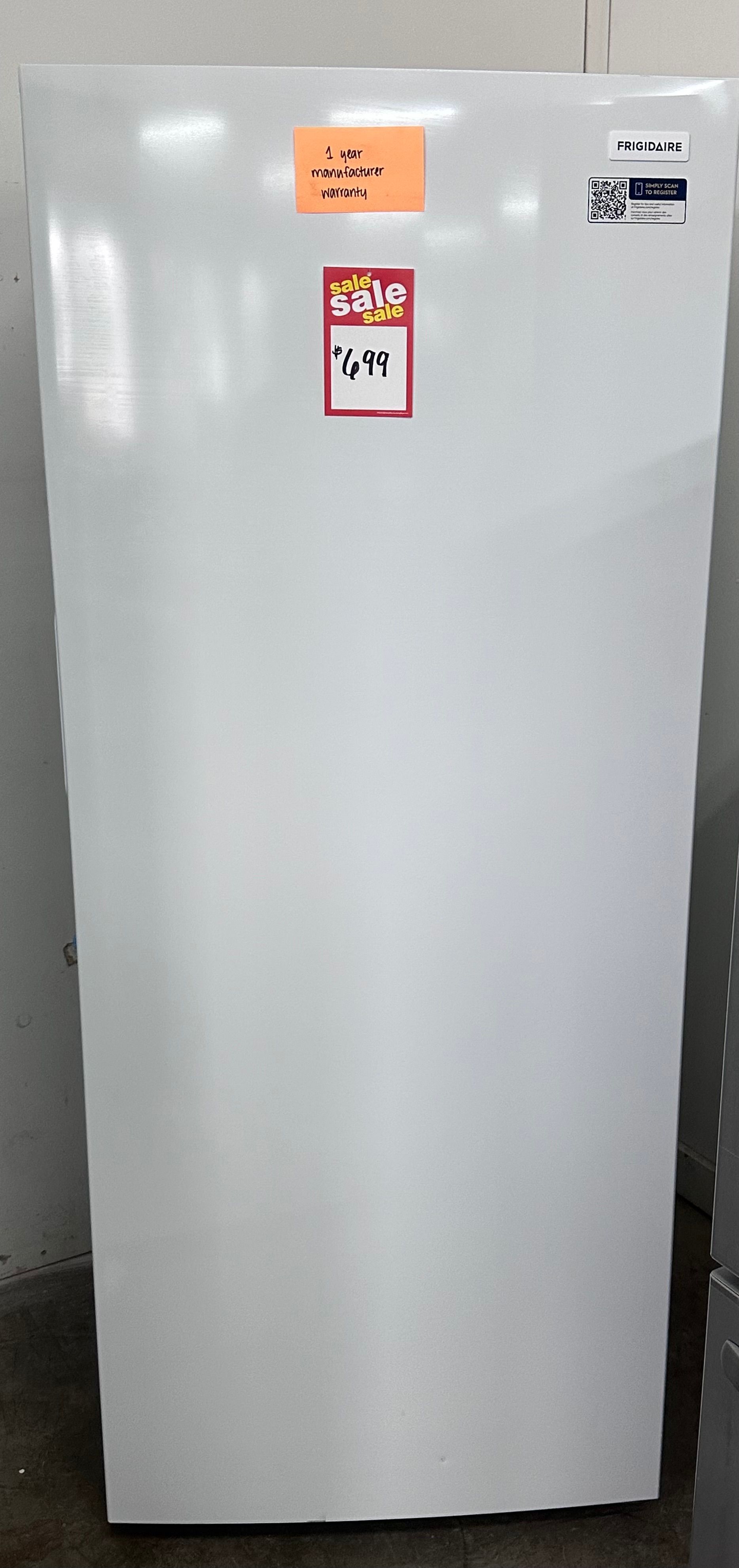 Stainless steel side-by-side refrigerator with water dispenser and pink labels on the doors