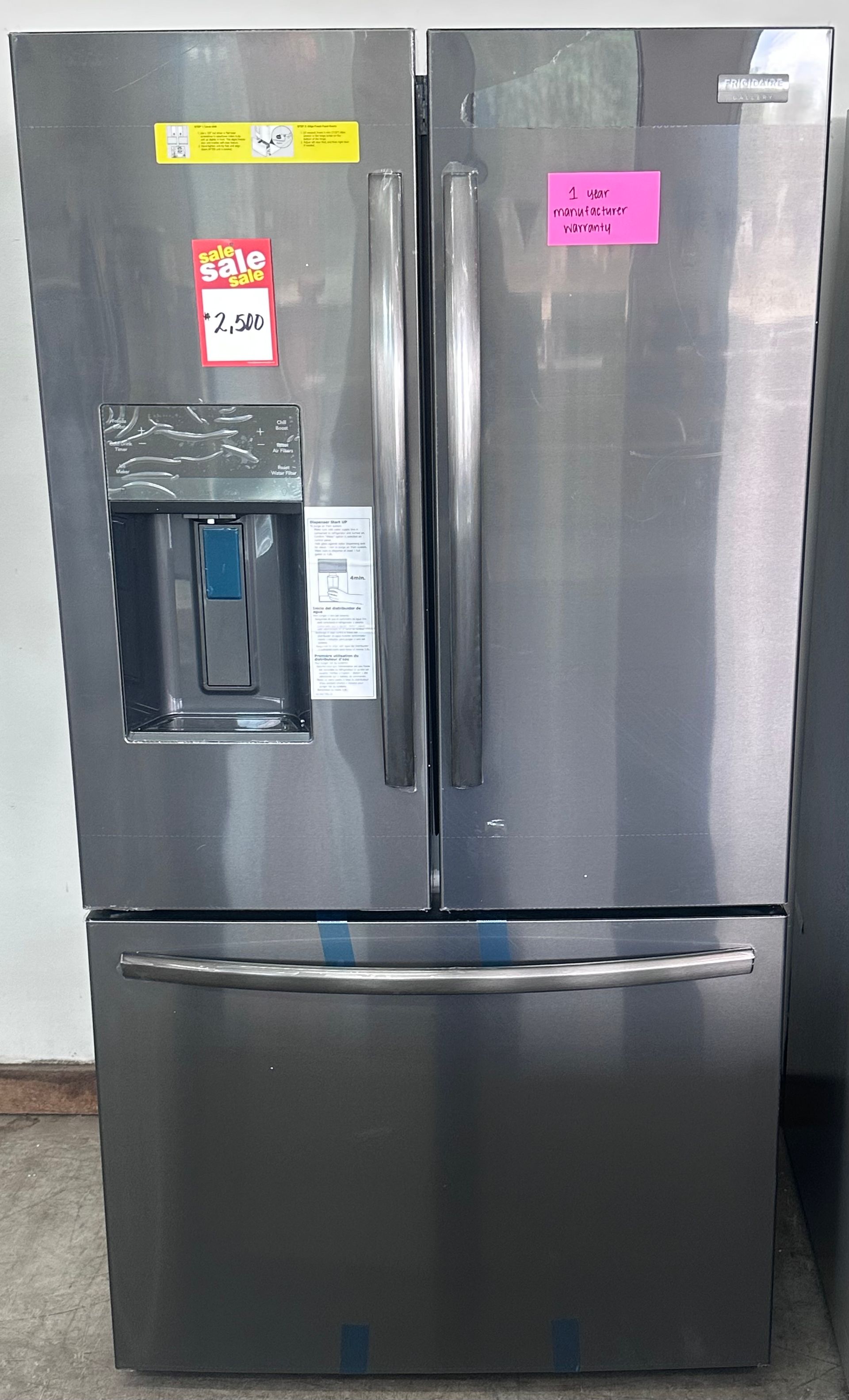 Stainless steel French door refrigerator with water dispenser and a bottom freezer drawer.