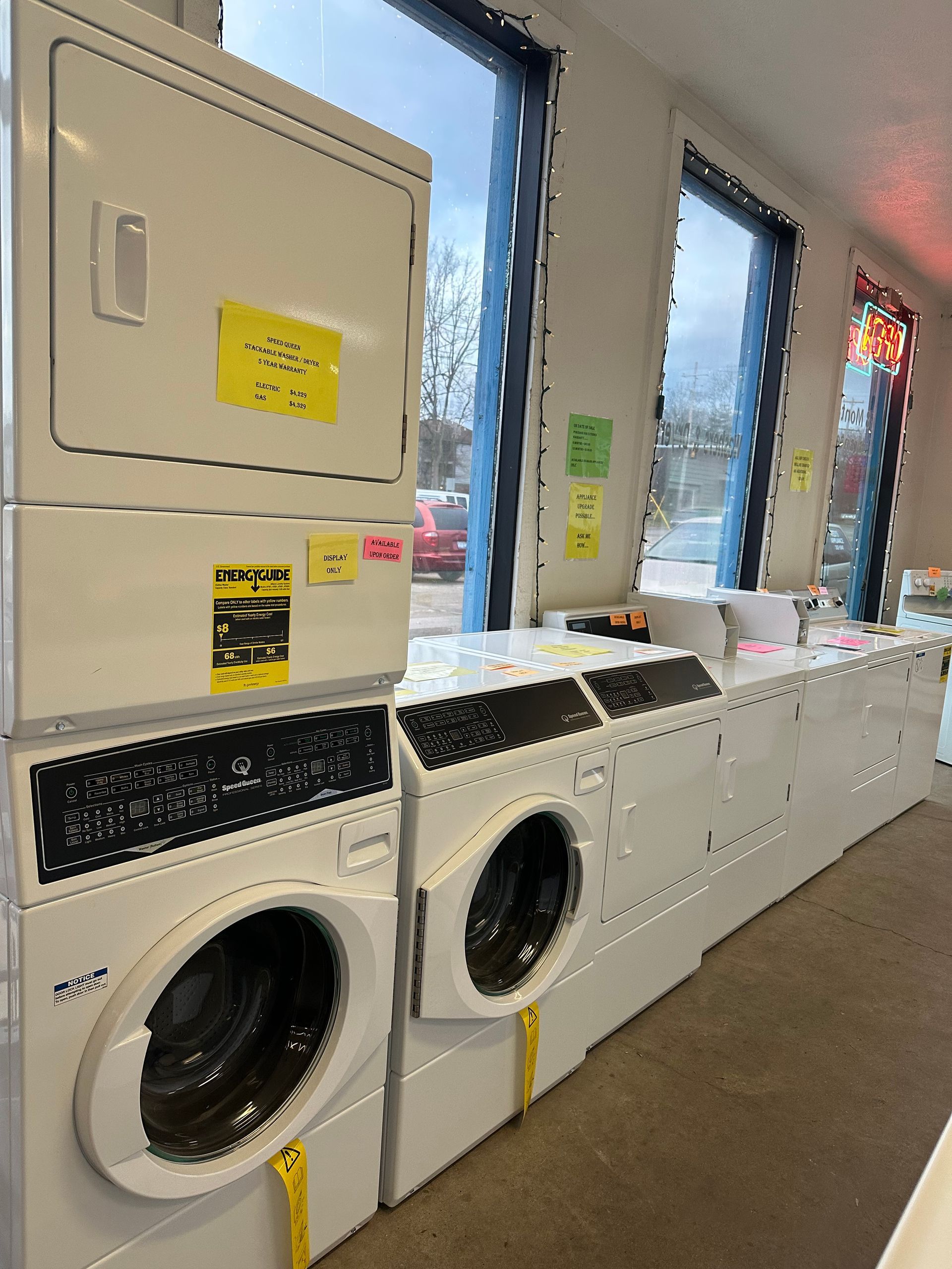 A washer and dryer are stacked on top of each other in a laundromat.