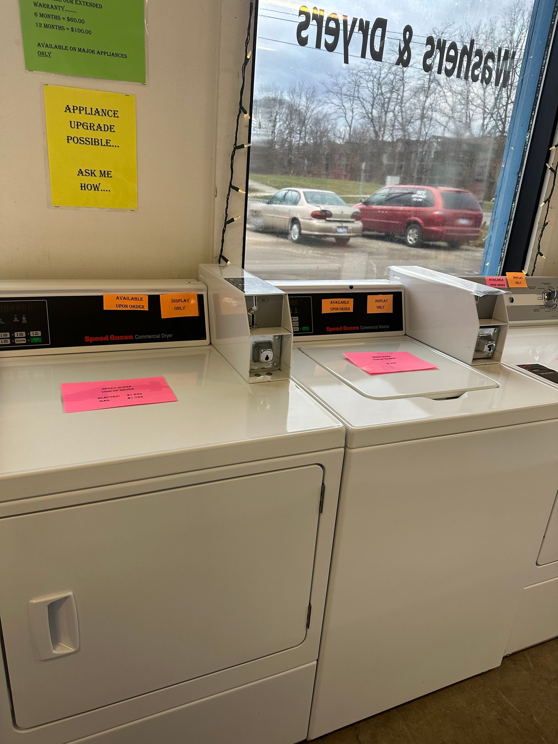 A laundromat with a washer and dryer in it