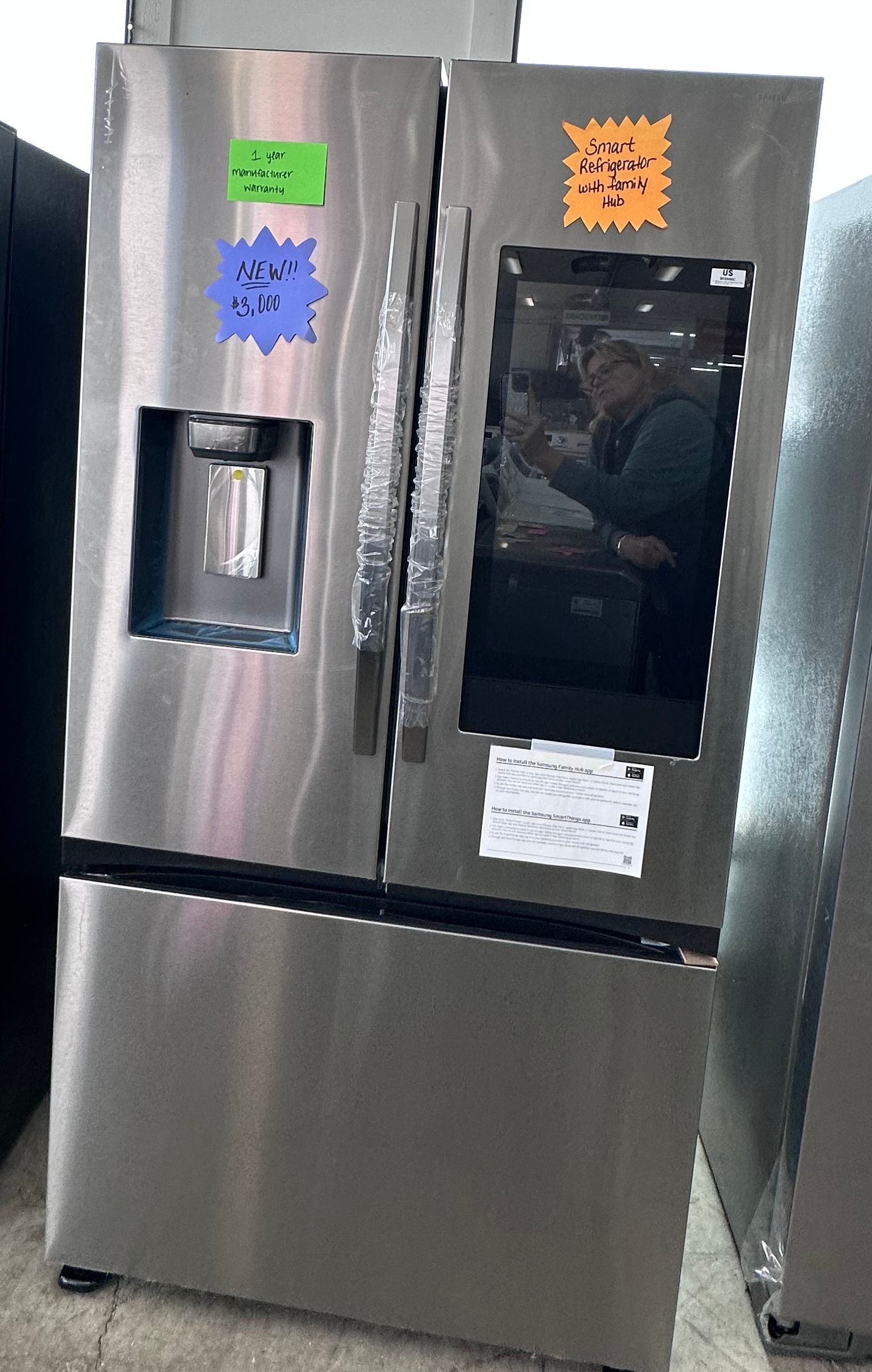Stainless steel French door refrigerator with an interactive door panel.
