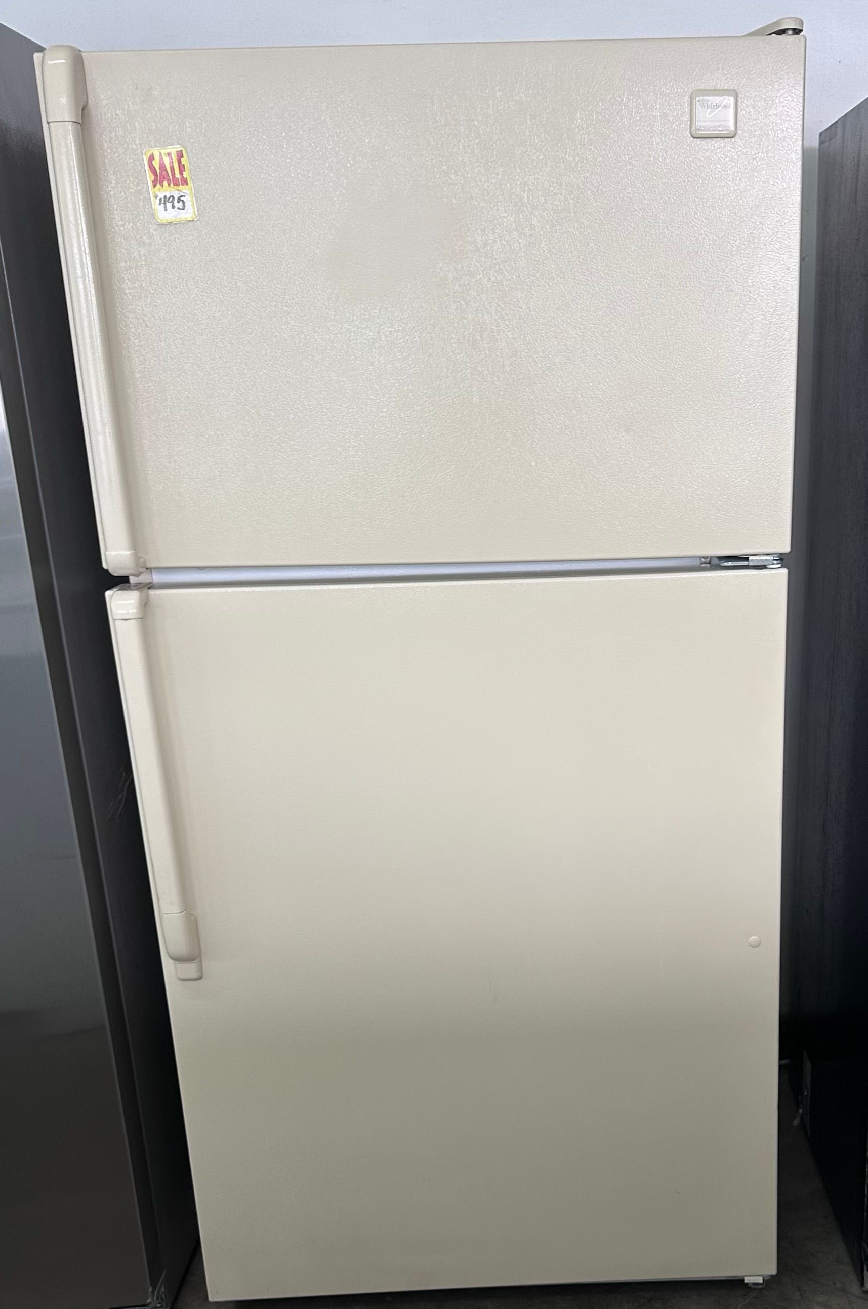 Beige top-freezer refrigerator with two doors.