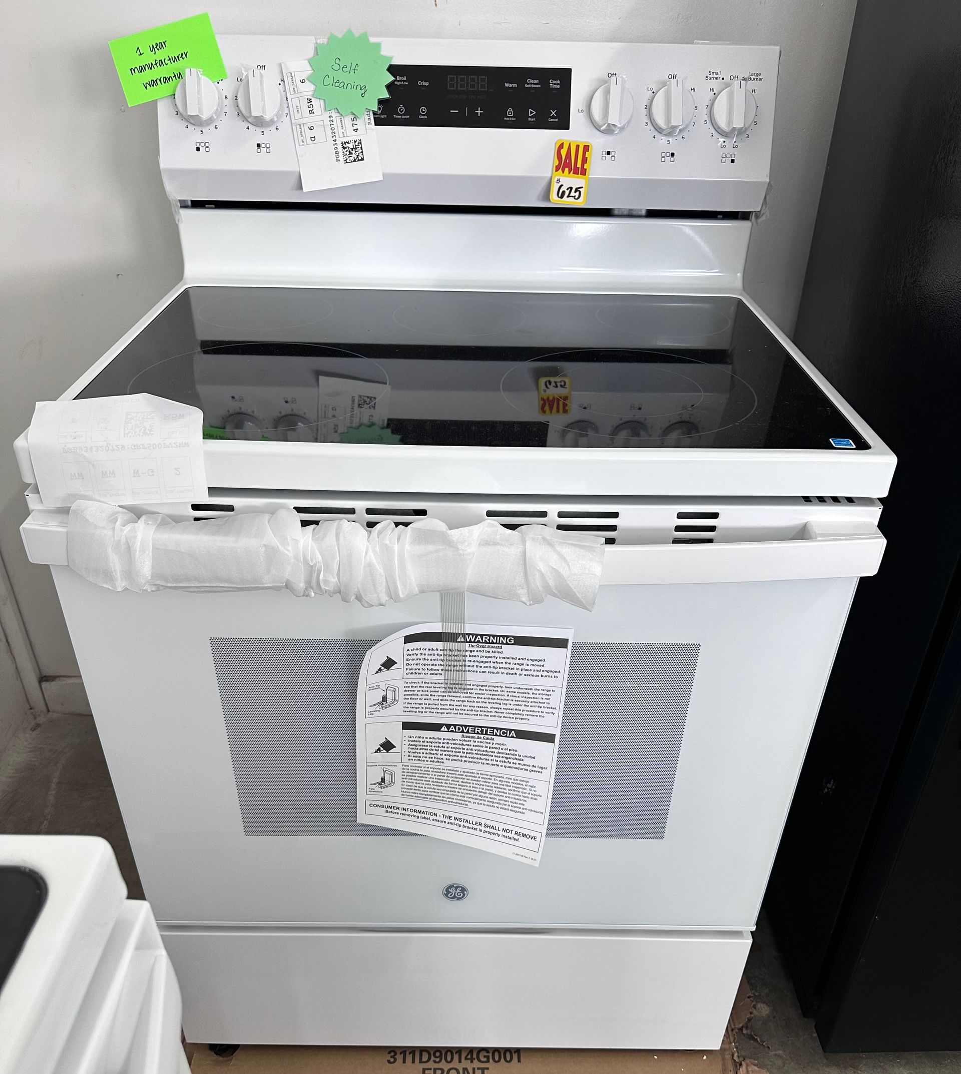 White electric range with black cooktop, control panel with knobs, and bottom drawer.